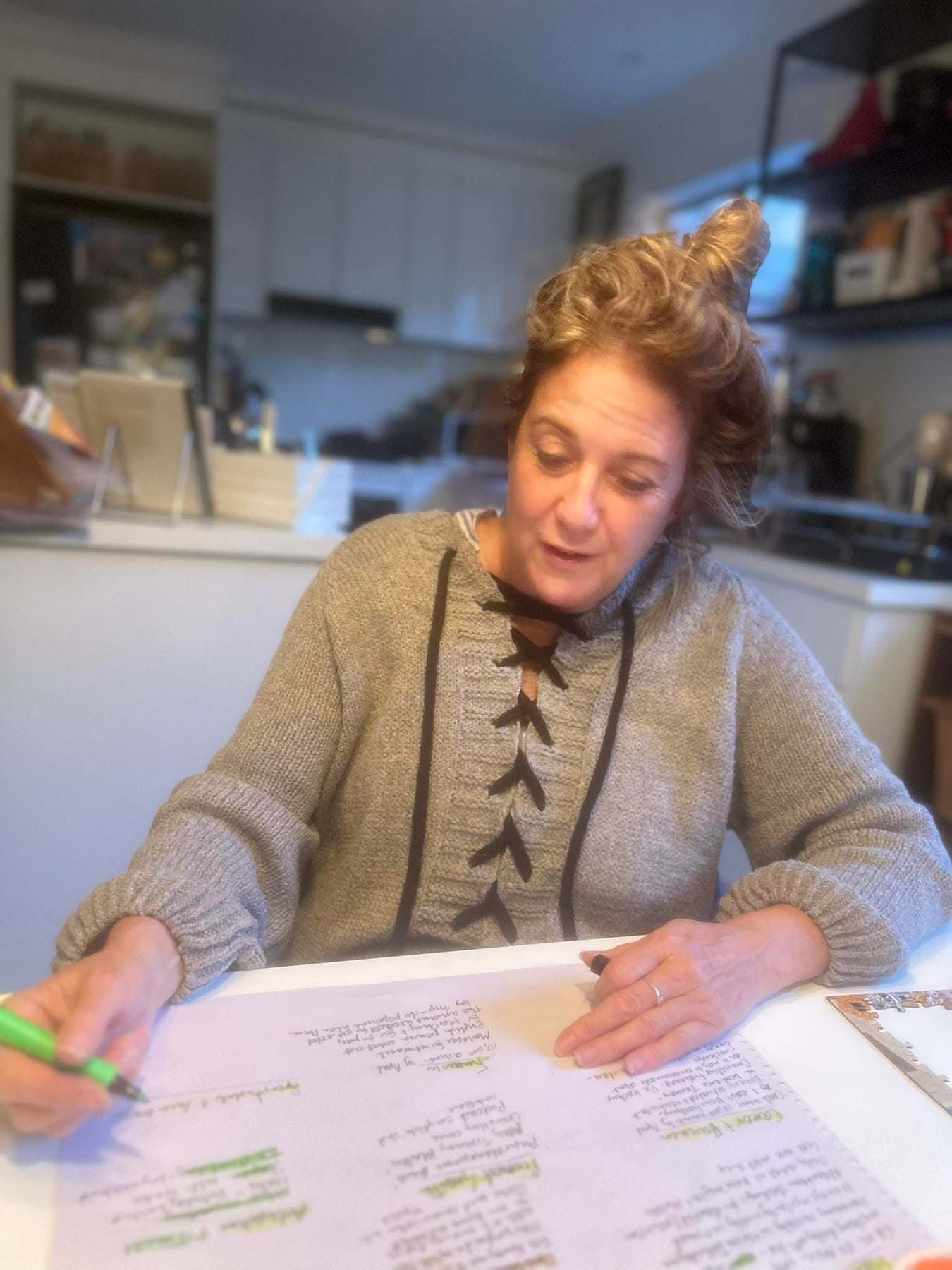 Jules writing coaching notes at her kitchen table